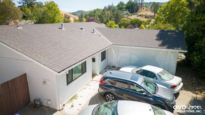 Modern home exterior in Pinole, CA featuring new James Hardie siding in Arctic White and asphalt shingle roof
