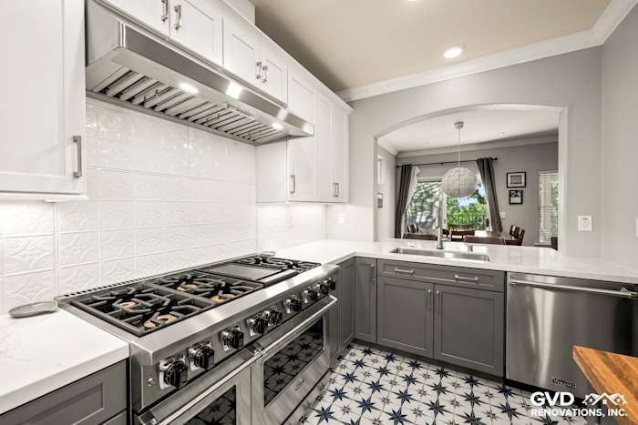 Modern kitchen featuring gray cabinetry, stainless steel appliances, and geometric patterned tile flooring in Folsom, CA