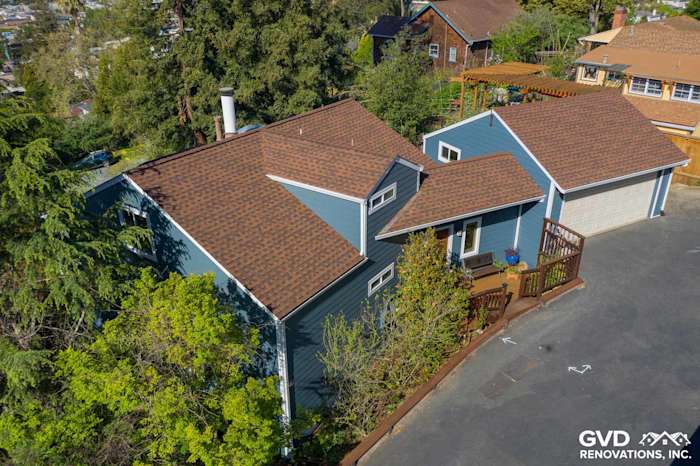 Modern home exterior featuring James Hardie lap siding in blue and new roofing in Oakland, CA