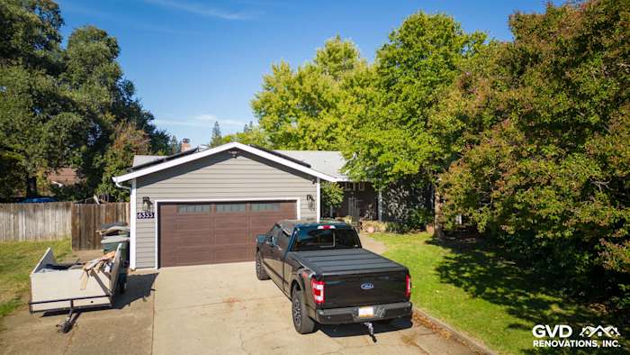 Front exterior of a home in Carmichael featuring Alside Prodigy vinyl siding, Milgard windows, and a black truck