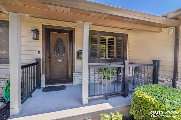 New Alside Prodigy vinyl siding and gutters on a front porch in Rio Linda, featuring a decorative door and landscaping