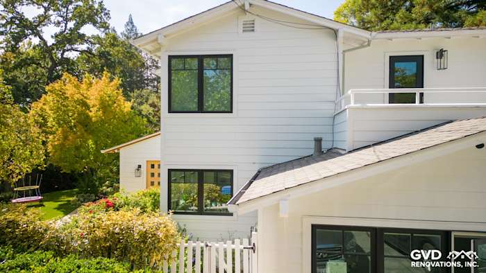 Modern home exterior featuring Arctic White James Hardie siding and windows in Orinda, CA with landscaped yard