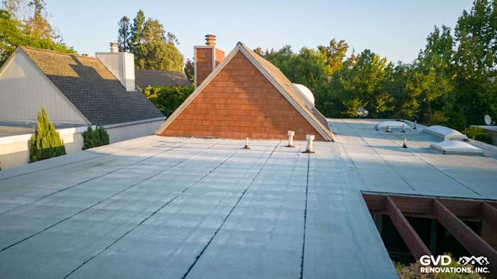 Flat roof view with new roofing material and surrounding homes in a residential area in Sonoma, CA