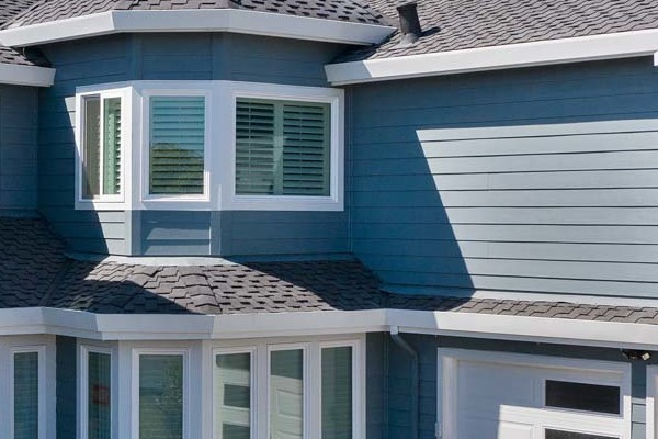 Foster City home exterior featuring Boothbay Blue HardiePlank siding, Arctic White trim, and a paved driveway