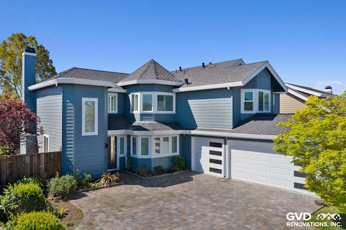 Foster City home exterior featuring Boothbay Blue HardiePlank siding, Arctic White trim, and a paved driveway
