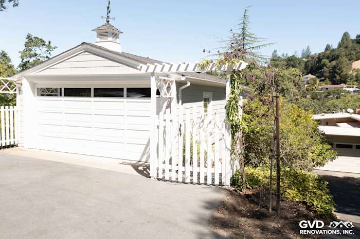 Garage with James Hardie Shingle Siding in Pearl Gray, white trim, and a stylish gable