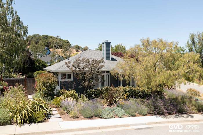 San Rafael home featuring James Hardie Evening Blue lap siding and Arctic White trim, surrounded by lush landscaping