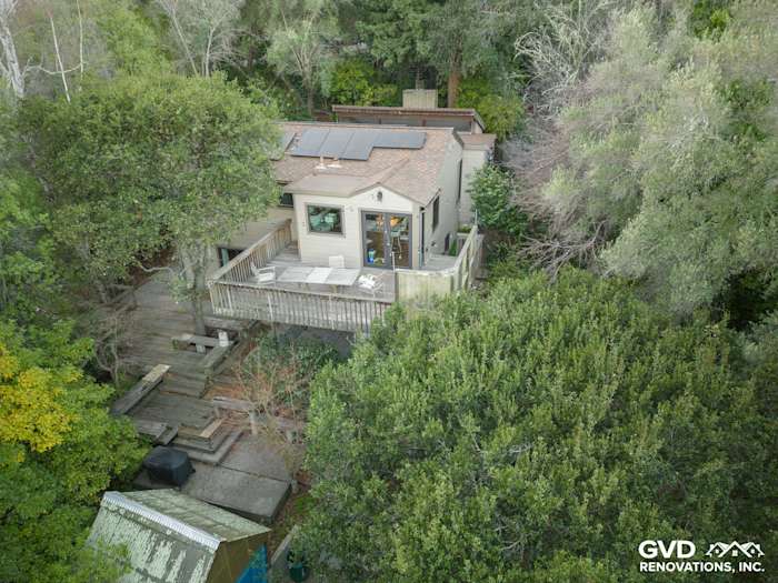Aerial view of an Oakland home featuring James Hardie siding, Timber Bark trim, and Marvin windows amidst lush greenery