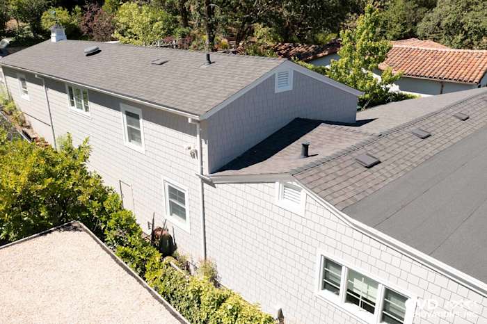 James Hardie Shingle Siding in Pearl Gray on a modern home exterior with lush greenery in Orinda, CA