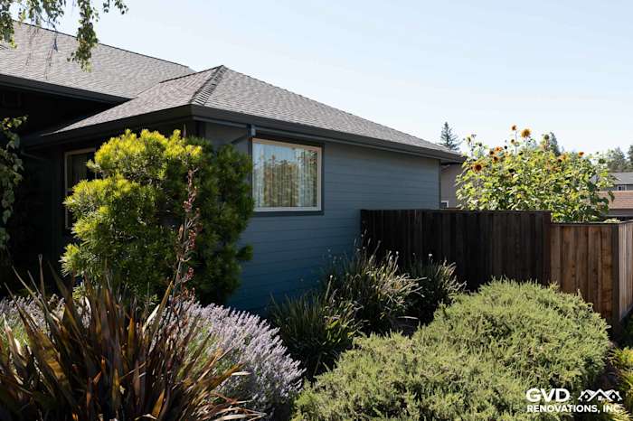 Boothbay Blue James Hardie siding and Milgard window on a home, surrounded by greenery in Rohnert Park