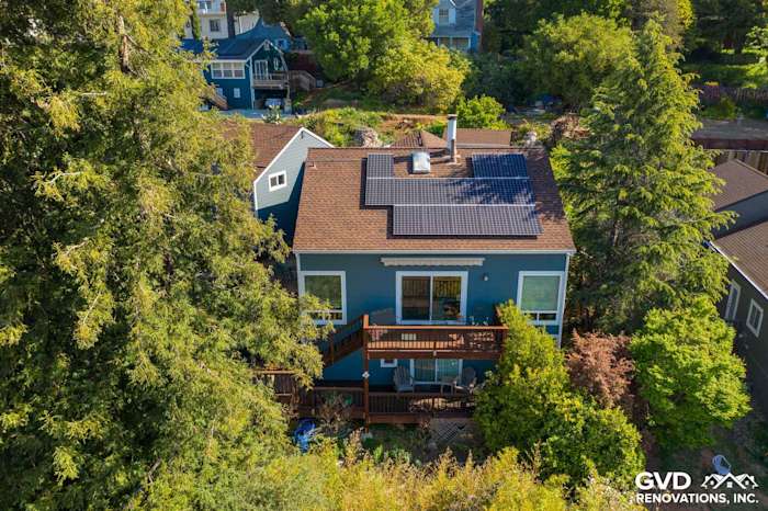 Two-story home featuring James Hardie lap siding, solar panels, and a wooden deck in Oakland, CA