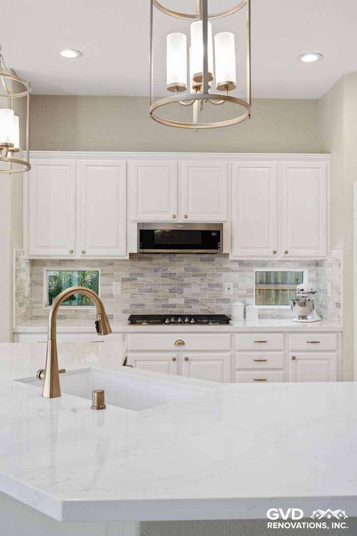 Modern Sacramento kitchen featuring white cabinets, quartz countertop, and decorative tile backsplash