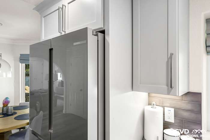 Modern kitchen featuring sleek gray refrigerator and light gray cabinets with chrome handles in Rocklin remodel