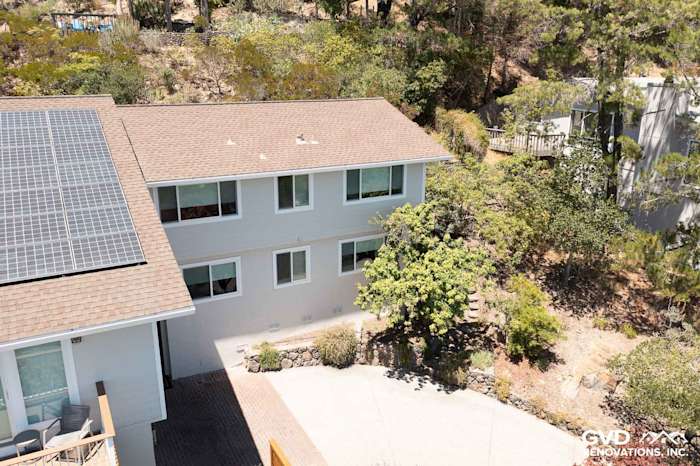 Home exterior featuring James Hardie siding in Cobble Stone and Andersen windows surrounded by lush greenery in San Rafael