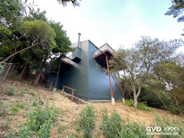 Updated home exterior featuring James Hardie siding in dark blue, set against a hillside in Mill Valley