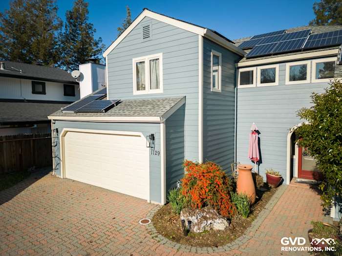Home exterior showcasing Boothbay Blue James Hardie siding with a brick driveway and solar panels in Davis, CA