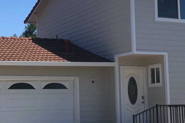 Two-story home featuring Arctic White James Hardie siding and Cobble Stone HardieSoffit with a brick entryway