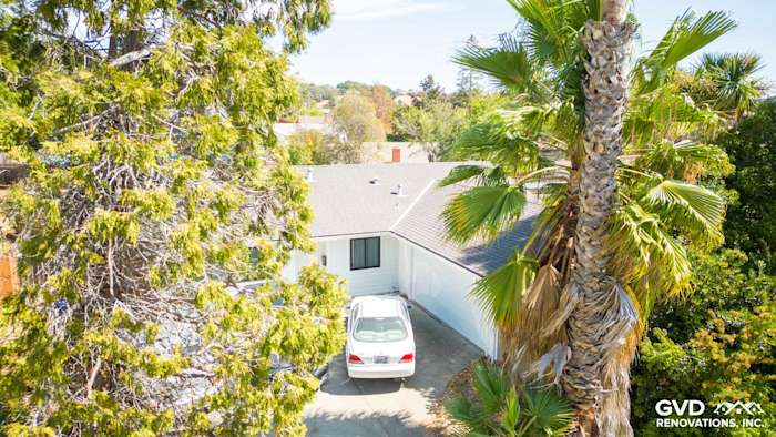 Home exterior featuring James Hardie Lap Siding in Arctic White surrounded by trees in Pinole, CA
