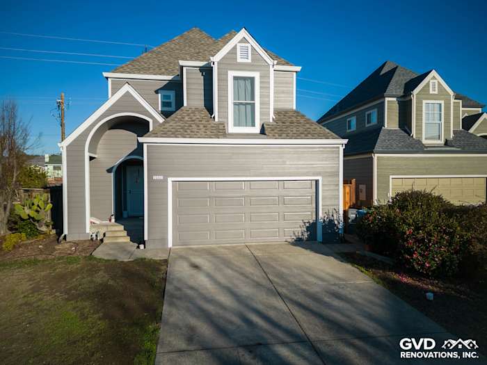 Modern home exterior featuring James Hardie Aged Pewter siding and a contemporary grey garage door in Santa Rosa