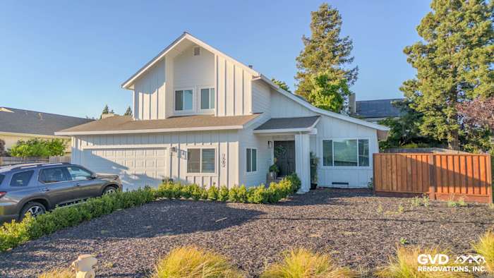 Two-story Petaluma home featuring James Hardie siding in Arctic White and Anlin windows, surrounded by landscaping