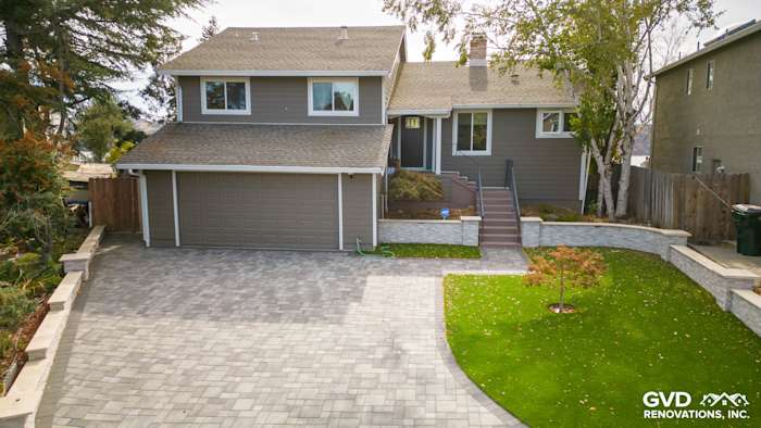 Home exterior featuring Timber Bark HardiePlank siding, Arctic White trim, and a stylish stone driveway
