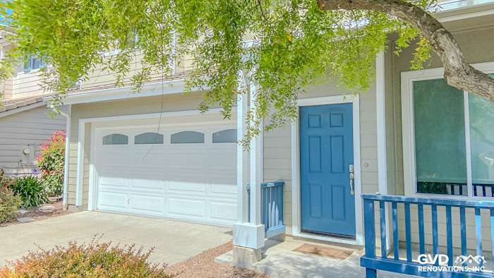 Richmond home exterior featuring Monterey Taupe James Hardie siding, Arctic White trim, and a bold blue front door