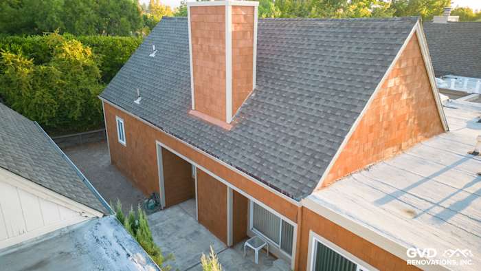 Cedar sidewall panel siding and new windows on a Sonoma home's exterior, featuring a sloped roof and chimney