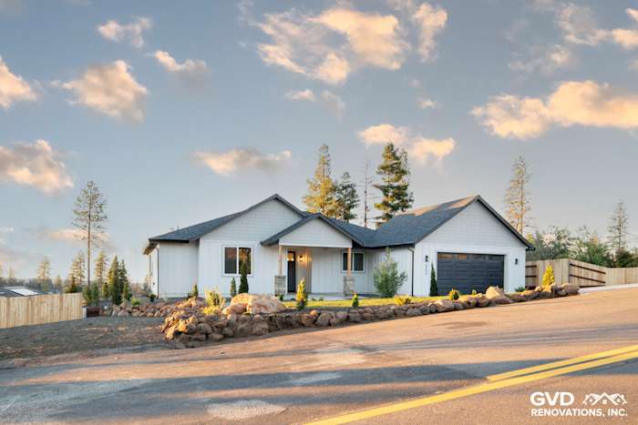 Custom-built home exterior in Paradise, CA featuring James Hardie Board and Batten Siding, modern roofline, and landscaped
