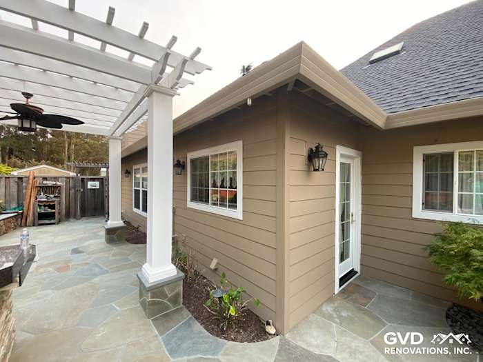 Khaki Brown James Hardie siding and trim on a home's exterior, featuring stone patio and updated windows