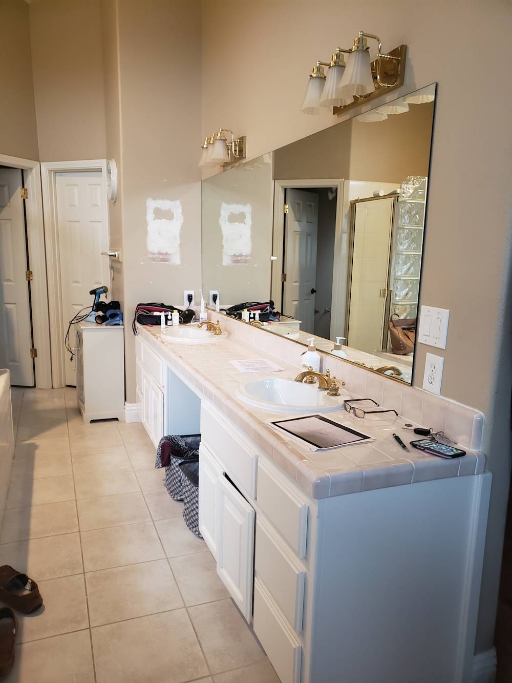 Dated Folsom bathroom with beige tiles, white cabinetry, and outdated fixtures