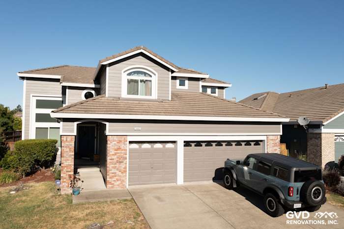 Two-story home in Petaluma with Aged Pewter James Hardie lap siding and Arctic White trim, featuring a black Jeep parked