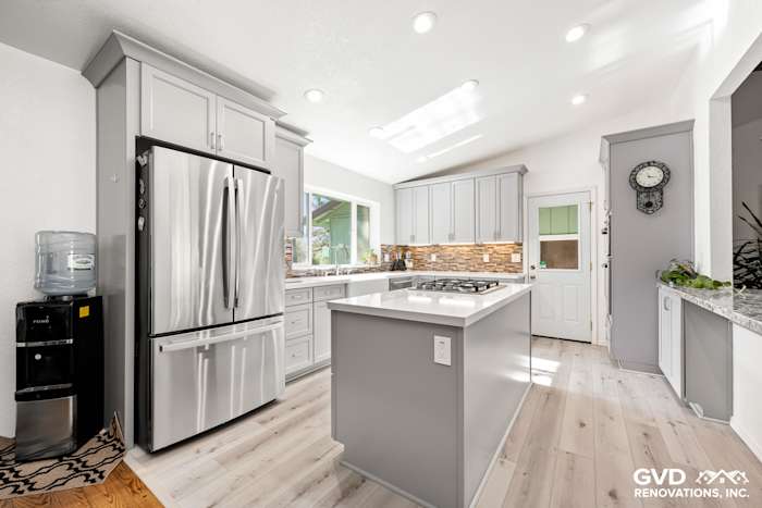 Modern kitchen remodel in Greenwood, CA featuring gray cabinetry, stainless steel appliances, and quartz countertops