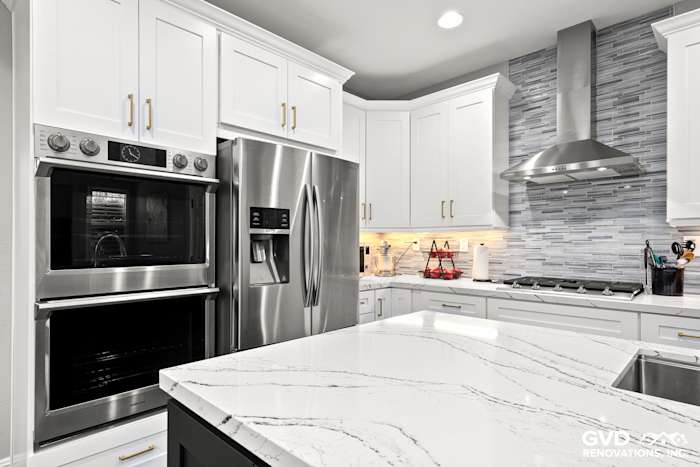 Modern kitchen with Cambria quartz countertops, stainless steel appliances, and white shaker cabinets in Roseville, CA