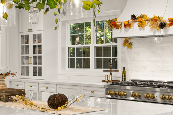 Modern kitchen in Granite Bay with quartz countertops, white cabinetry, and pendant lighting, featuring a large island