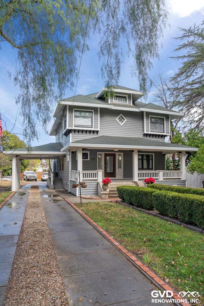 Updated two-story home exterior featuring gray vinyl siding, white trim, and landscaped front yard in Dixon, CA