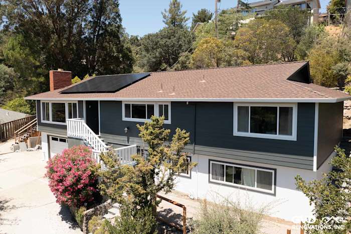 Two-story home exterior featuring James Hardie Iron Gray siding, Arctic White trim, and solar panels in San Rafael