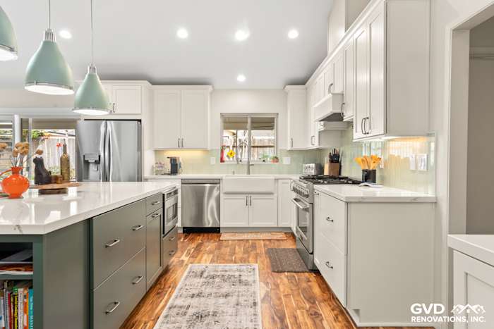Modern kitchen remodel in Carmichael featuring custom island cabinets, stainless steel appliances, and stylish pendant