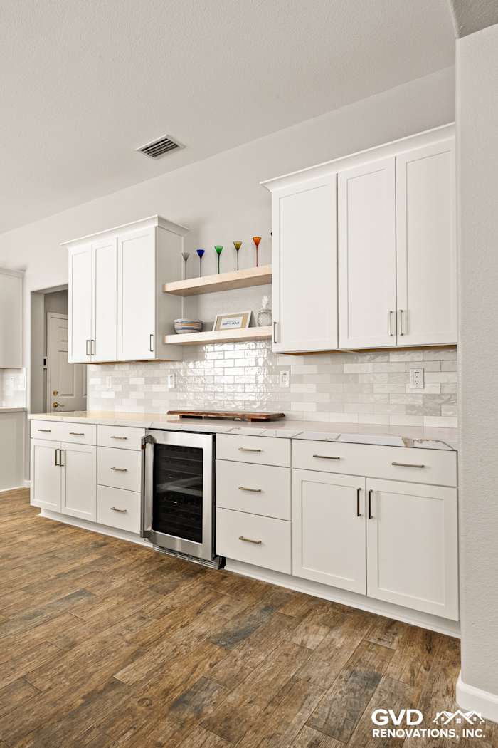 Modern kitchen remodel in Roseville featuring white Diamond cabinets, floating shelves, and stylish subway tile backsplash