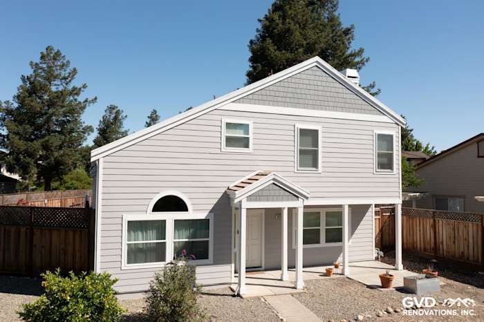 Home exterior showcasing Pearl Gray James Hardie siding and Arctic White trim, featuring new Simonton windows