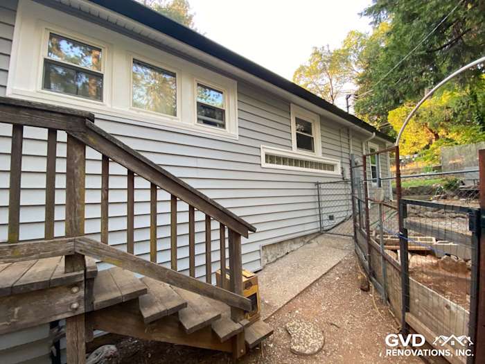 New Prodigy Vinyl Siding in light gray, showcasing upgraded exterior and wooden steps in Grass Valley backyard