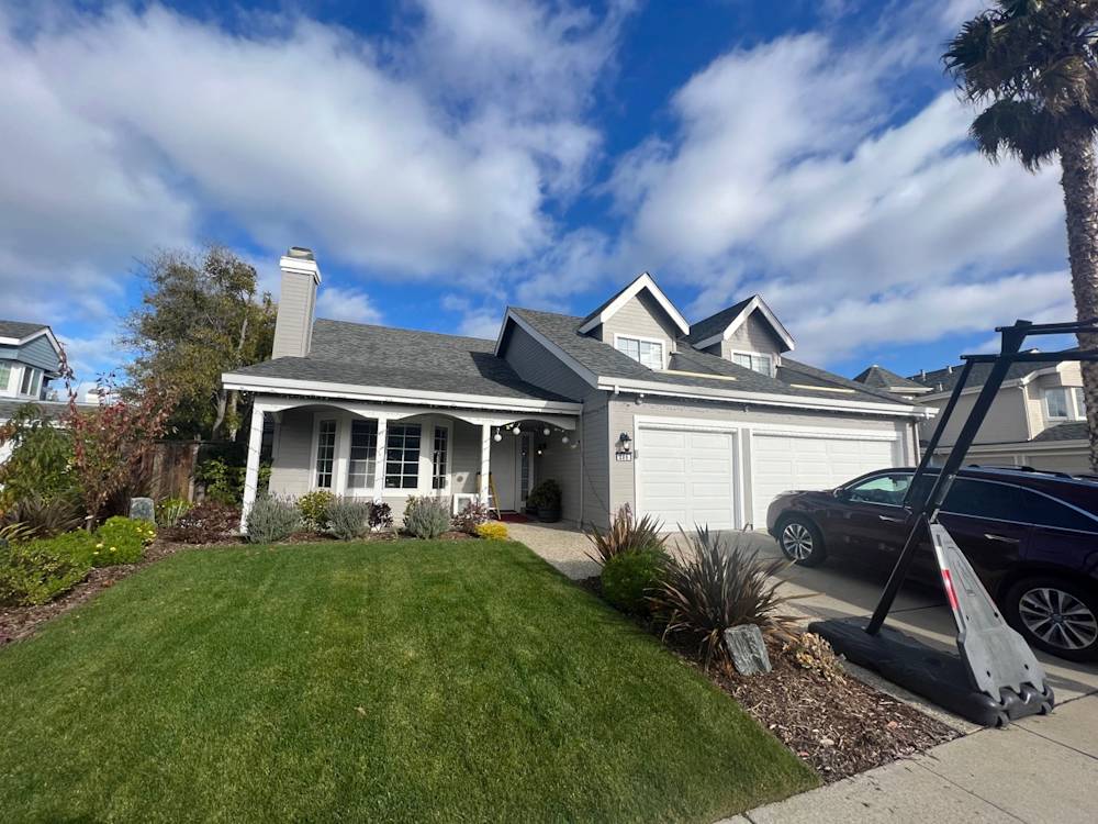 Charming Sacramento home with well-maintained lawn, lush greenery, and a welcoming porch
