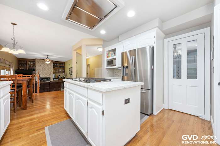 Modern kitchen renovation featuring white cabinetry, stainless steel appliances, and a large island in Fair Oaks, CA