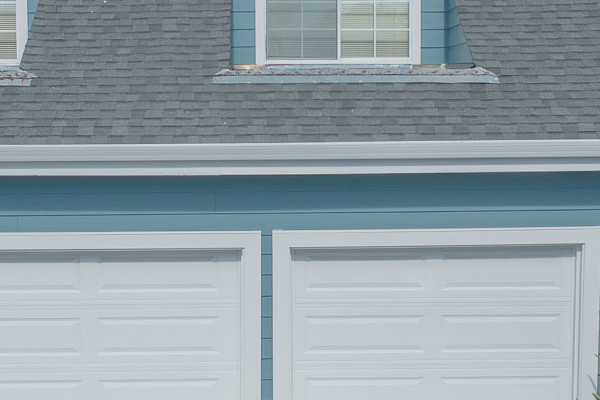 Home exterior with James Hardie siding in Boothbay Blue, Arctic White trim, and a landscaped driveway in Foster City