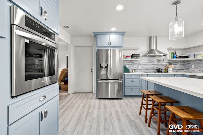 Modern kitchen remodel in Elk Grove featuring blue Waypoint cabinets, MSI Calacatta Ultra countertops, and Misty Fjord