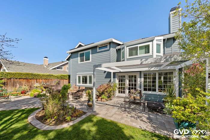 Foster City home with Boothbay Blue HardiePlank siding, Arctic White trim, and outdoor patio area