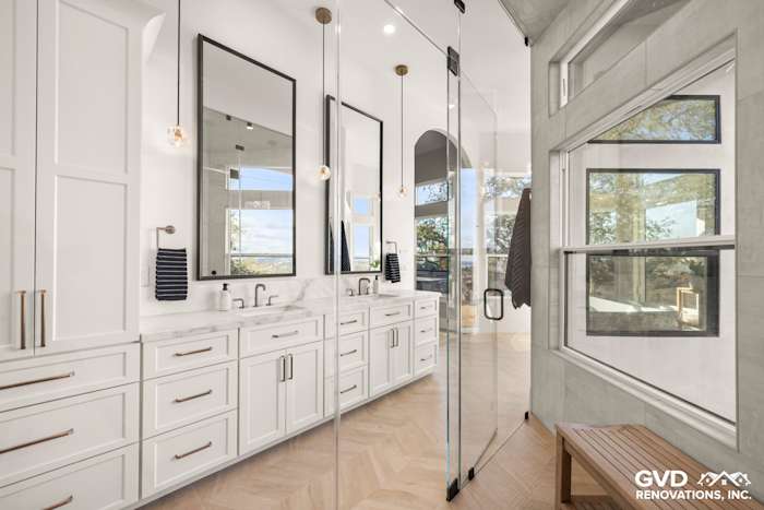 Luxurious El Dorado Hills master bathroom with dual vanities, marble countertops, large mirrors, and a glass shower enclosure