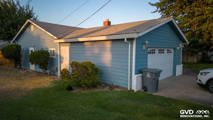 Home exterior featuring new Alside Prodigy vinyl siding in light blue, showcasing improved curb appeal