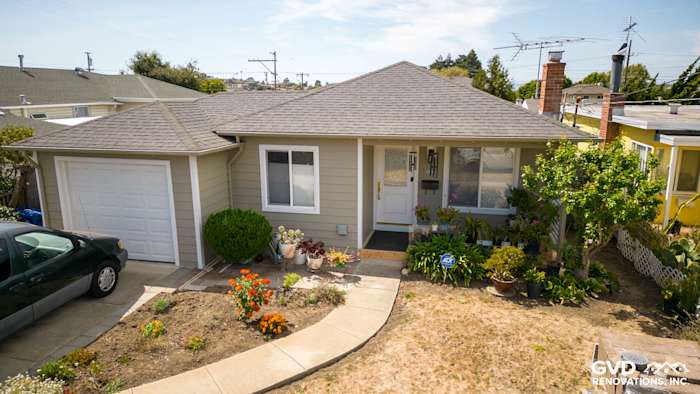 Home exterior in El Cerrito featuring James Hardie Monterey Taupe siding and Arctic White trim, landscaped front yard
