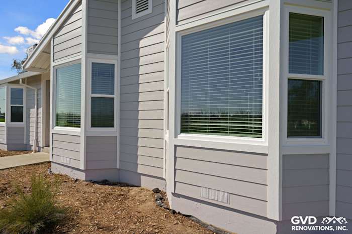 Pearl Gray James Hardie Siding with Arctic White trim and Anlin Windows on a home's exterior in Galt, CA