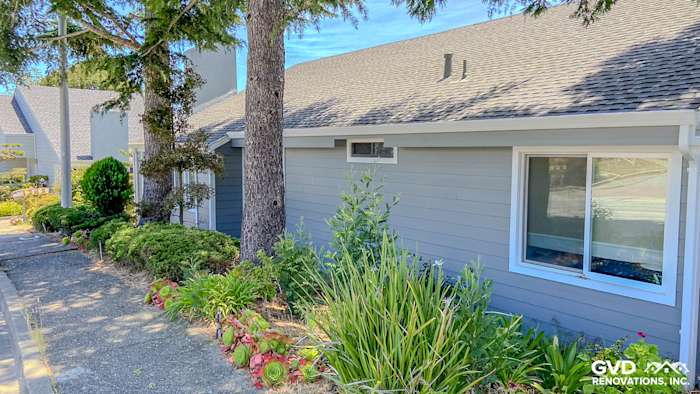 Gray Slate James Hardie lap siding with Arctic White trim on a Millbrae home surrounded by lush landscaping